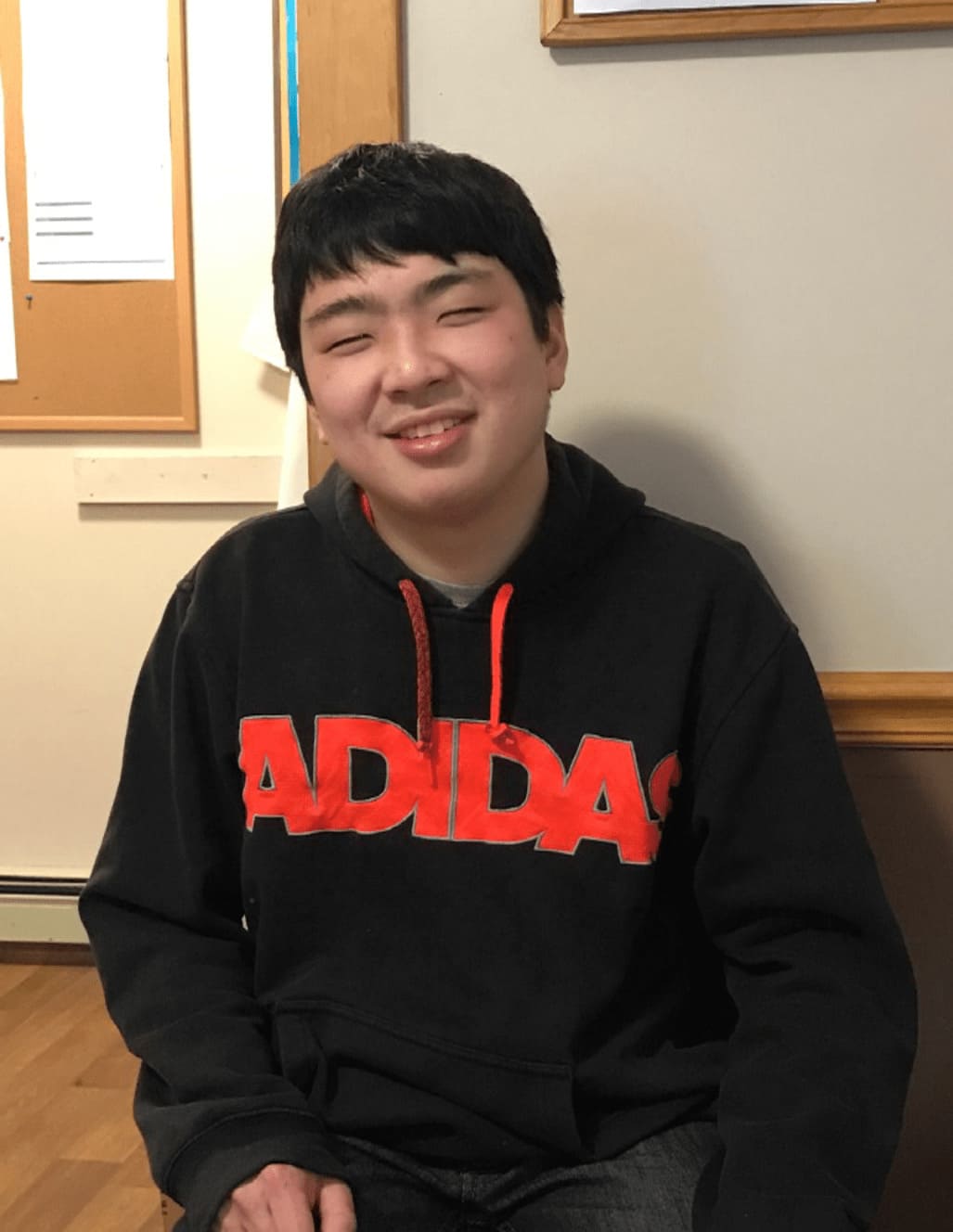 Patrick wearing black sweatshirt with red lettering